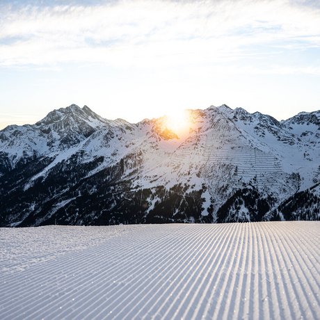Ihre Unterkunft in St. Christoph am Arlberg: Bilder Sonnenaufgang über schneebedeckten Bergen mit frisch präparierter Skipiste