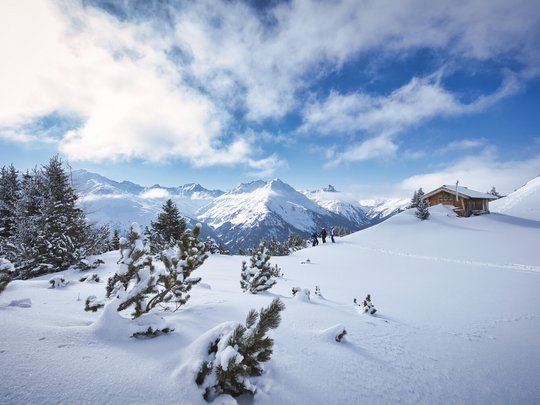 Hotel Maiensee: your hotel in St. Christoph Snow-covered mountain landscape with pine trees and a small wooden cabin under clear sky