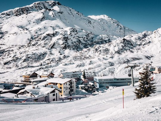 Hotel Maiensee: your hotel in St. Christoph Snow-covered mountain landscape with ski lift and village in the valley