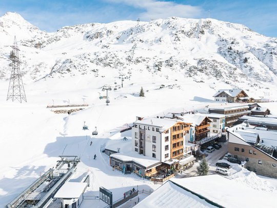 Your hotel in St. Christoph am Arlberg Snowy mountain village with ski lift and mountain in the background