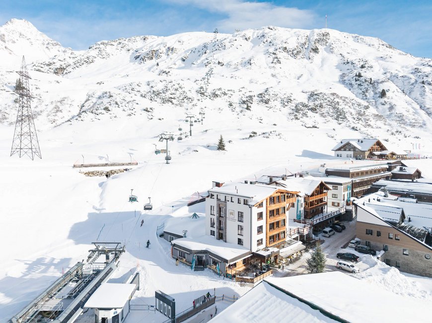 Hotel Maiensee: your hotel in St. Christoph Snowy mountain village with ski lift and mountain in the background