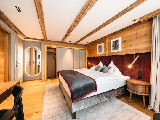 Your hotel in St. Christoph am Arlberg Cozy modern bedroom with wooden features and soft carpet