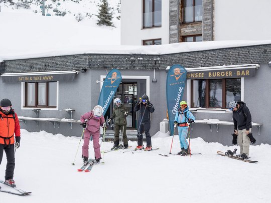 Hotel Maiensee: your hotel in St. Christoph Skiers in front of a burger bar building in the snow