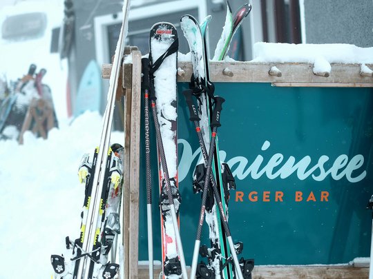 Premium burgers at the ski hotel near St. Anton am Arlberg Snow-covered skis on rack outside Mariensee Burger Bar