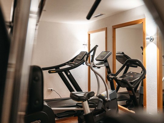 Maiensee: Ihr Wellnesshotel bei St. Anton Fitnessraum mit Laufband und Crosstrainer vor Spiegeln