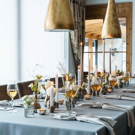Ihre Unterkunft in St. Christoph am Arlberg: Bilder Eleganter gedeckter Esstisch mit Kerzen, Blumen und Weingläsern in einem Restaurant