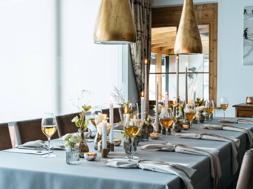 Your hotel in St. Christoph am Arlberg Elegant dining table set with candles, flowers, and wine glasses in a restaurant