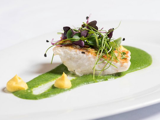 Hotel Maiensee: your hotel in St. Christoph Pan-seared fish fillet with green sauce, herbs, and two small dollops on white plate