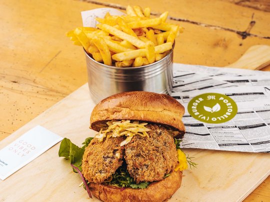 Premium burgers at the ski hotel near St. Anton am Arlberg Vegetarian burger with french fries served on a wooden board