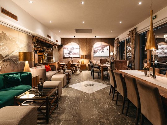 The lounge bar in your ski hotel at the Arlberg Cozy restaurant interior with wooden furniture and alpine decorations