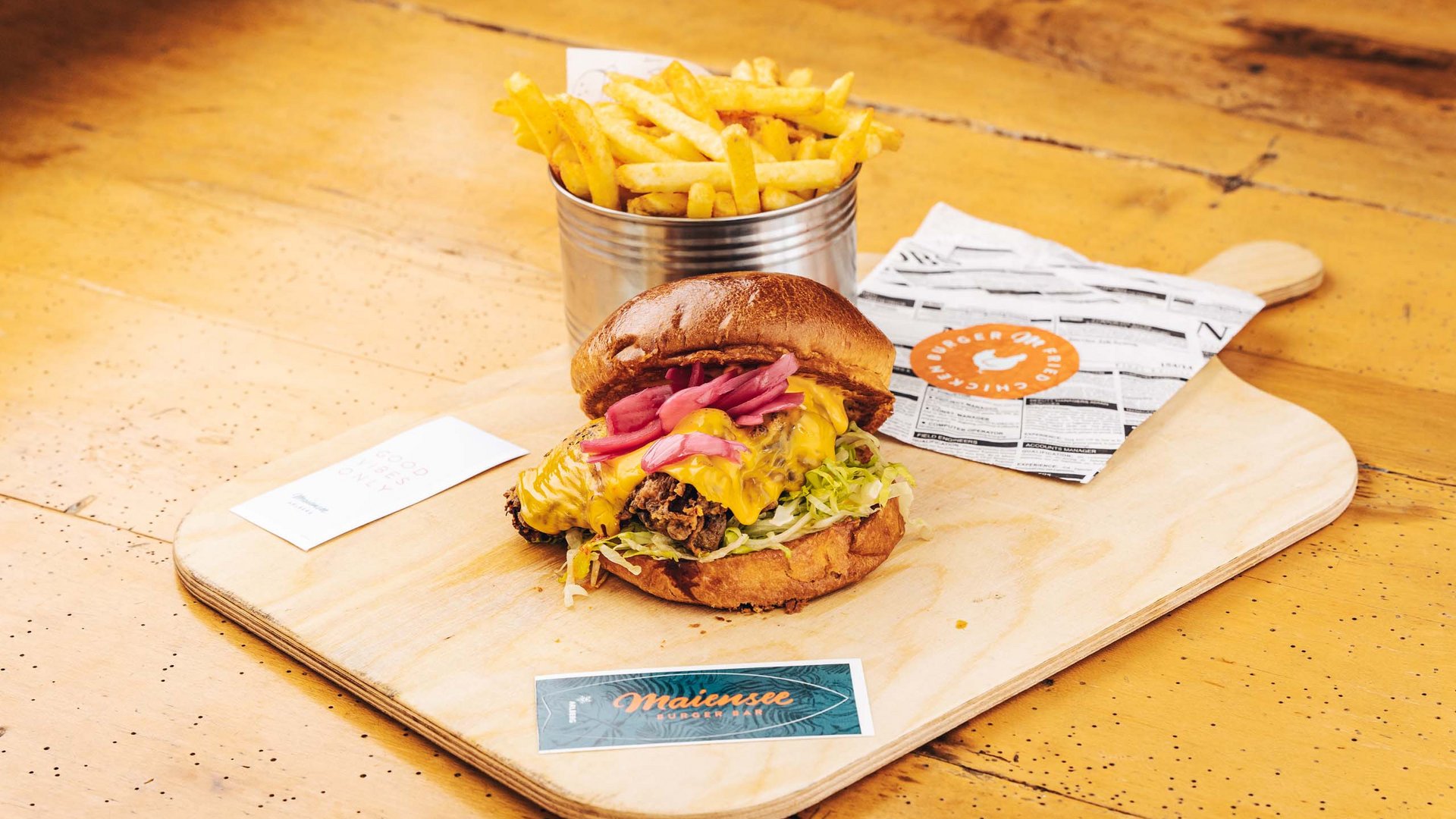 Premium burgers at the ski hotel near St. Anton am Arlberg Cheeseburger with lettuce and fries served on wooden board