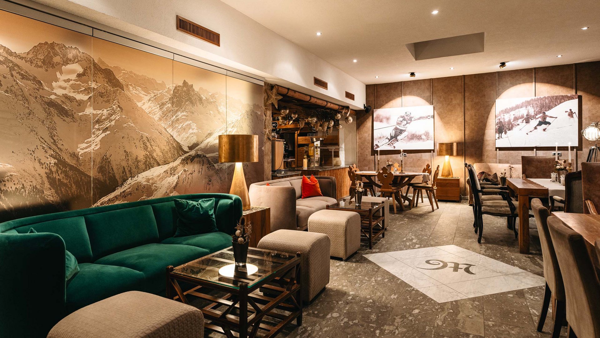 Your event in our hotel near St. Anton Cozy dining area with mountain mural and wooden furniture