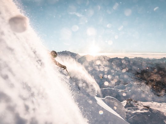 Hotel Maiensee: your hotel in St. Christoph Skier riding through powder snow with mountain scenery in the background