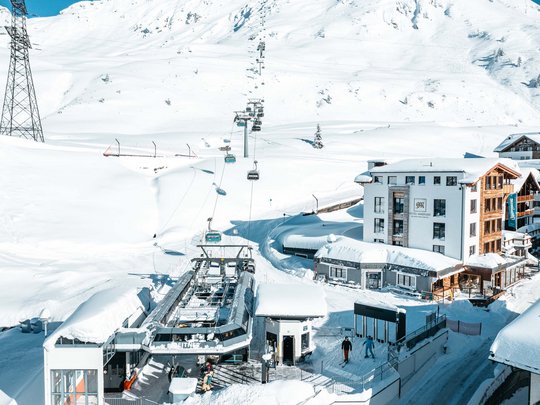 Hotel Maiensee: your hotel in St. Christoph Cable car station and snowy landscape with hotel in winter
