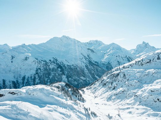 Your hotel in St. Christoph am Arlberg Snow-covered mountains under bright sunshine