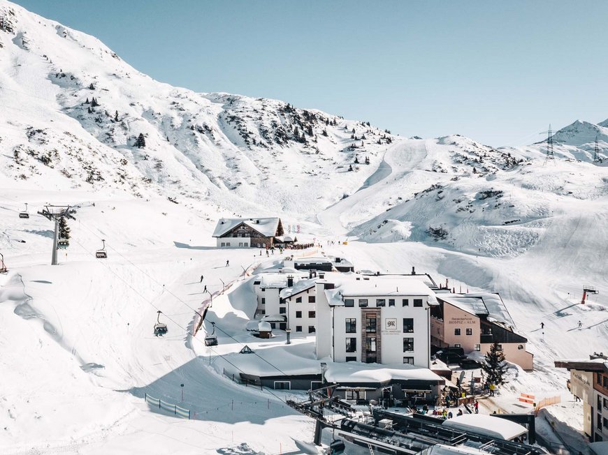 Hotel Maiensee: your hotel in St. Christoph Snow-covered ski resort with chairlifts and buildings under clear sky