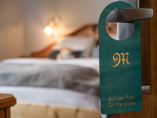 Your hotel in St. Christoph am Arlberg Door hanger with On the slopes text on a hotel room door handle